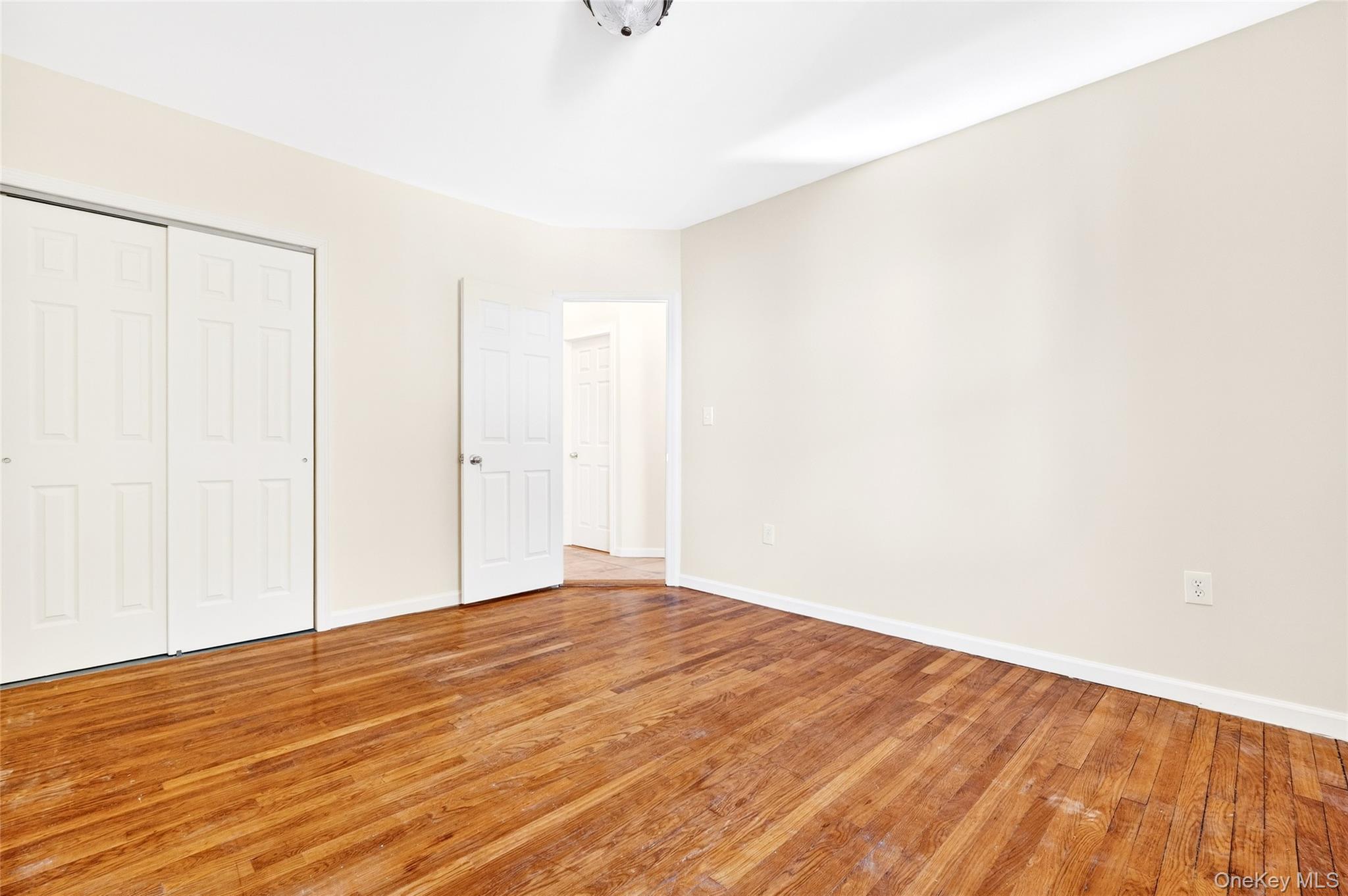 989 Sacket Avenue Bronx, NY 10462 - Photo 13 of 29 a view of empty room with wooden floor