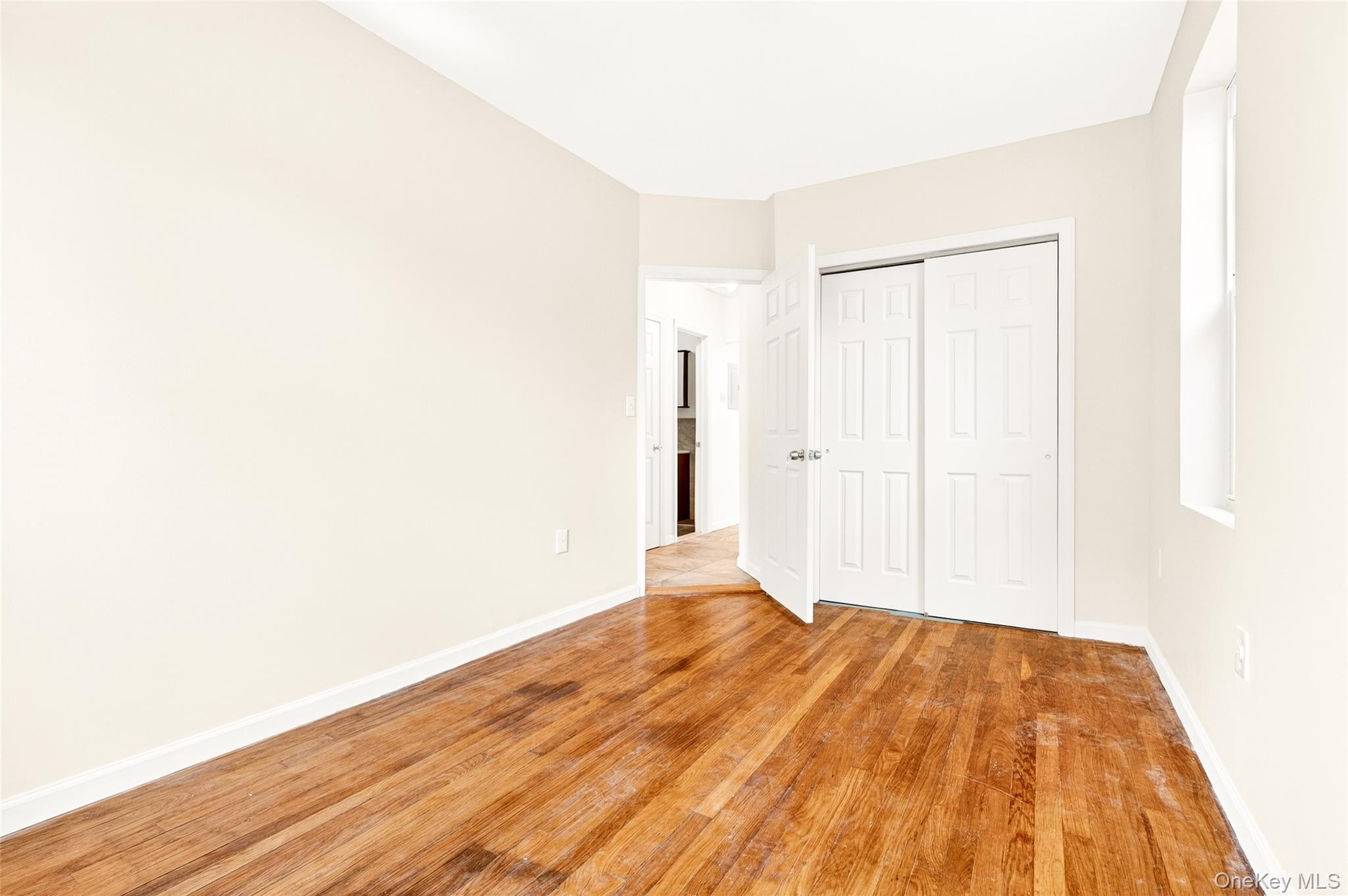 989 Sacket Avenue Bronx, NY 10462 - Photo 15 of 29 a view of a room with wooden floor and white walls