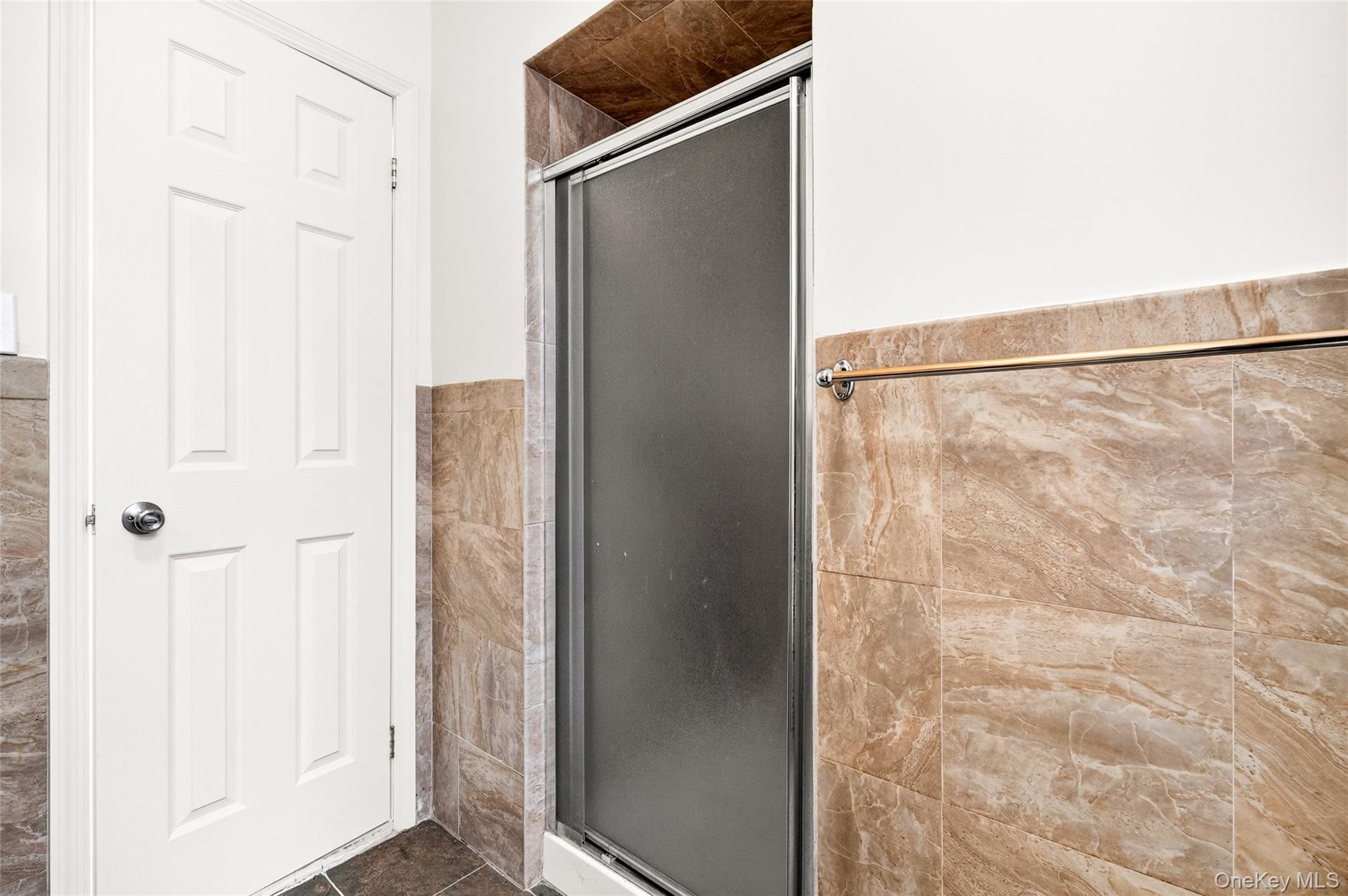 989 Sacket Avenue Bronx, NY 10462 - Photo 17 of 29 a bathroom with a shower and a glass door