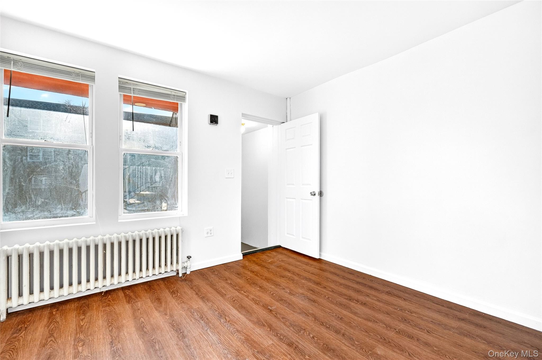 989 Sacket Avenue Bronx, NY 10462 - Photo 23 of 29 a view of a room with wooden floor and a window