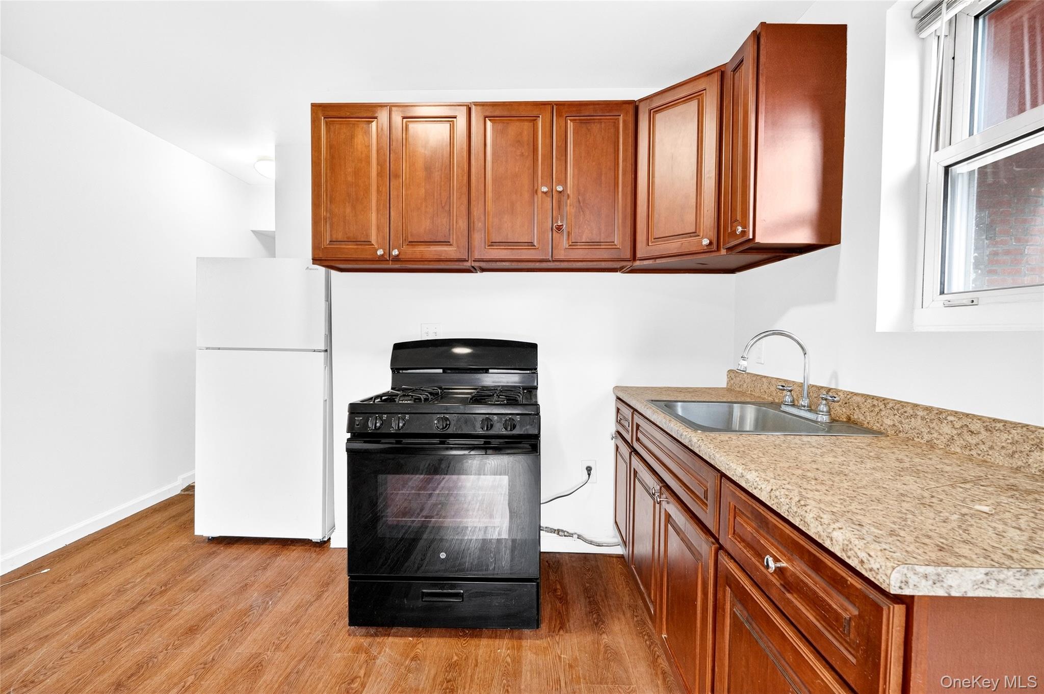 989 Sacket Avenue Bronx, NY 10462 - Photo 24 of 29 a kitchen with stainless steel appliances granite countertop a stove and a sink