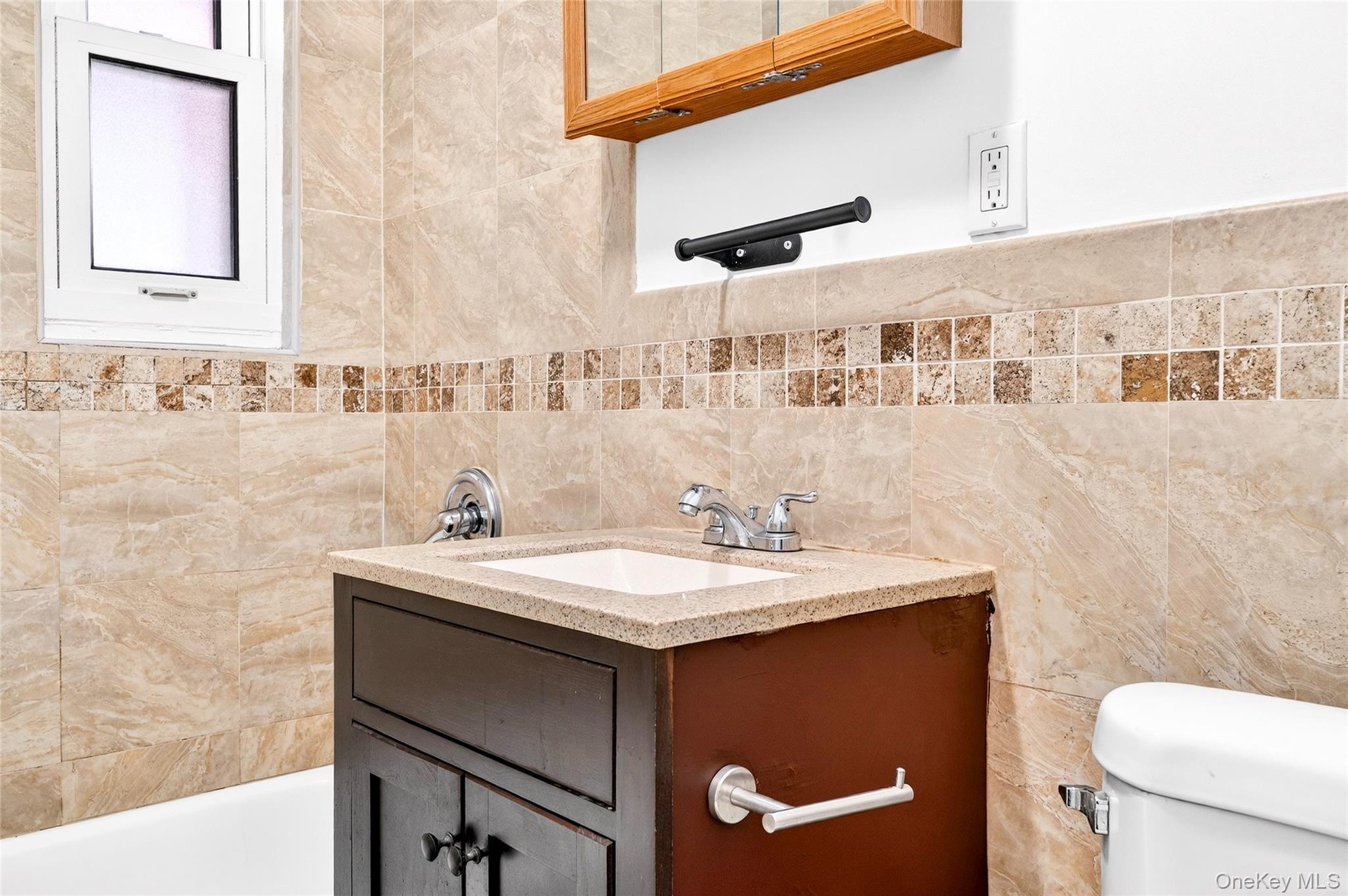 989 Sacket Avenue Bronx, NY 10462 - Photo 26 of 29 a bathroom with a sink a toilet and a mirror