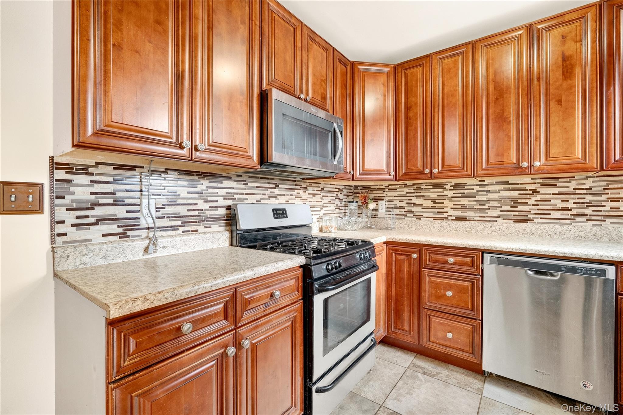 989 Sacket Avenue Bronx, NY 10462 - Photo 8 of 29 a kitchen with stainless steel appliances granite countertop a sink stove and cabinets