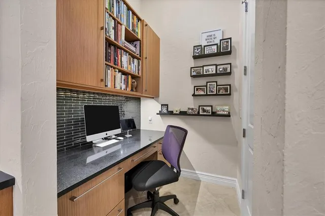 a kitchen with stainless steel appliances a stove a refrigerator a sink and dining table with wooden floor