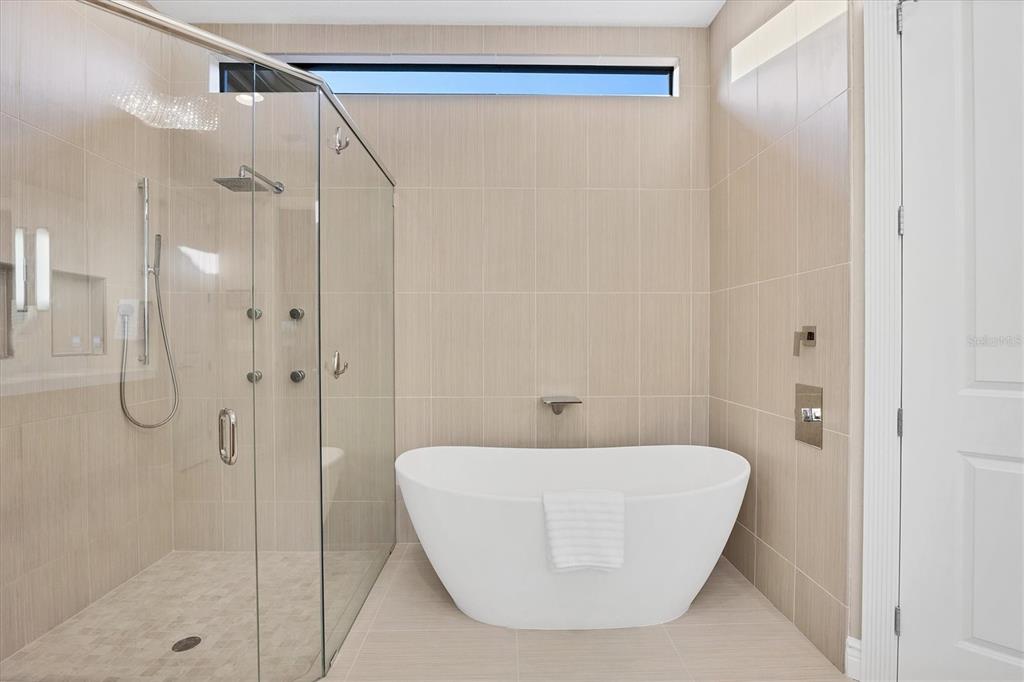 14519 Leopard Creek Place Lakewood Ranch, FL 34202 - Photo 25 of 56 a bathroom with a bathtub and shower
