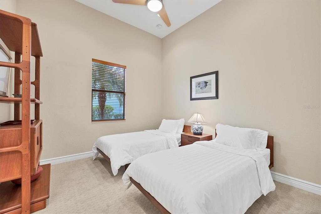 14519 Leopard Creek Place Lakewood Ranch, FL 34202 - Photo 27 of 56 a bedroom with two beds and a window