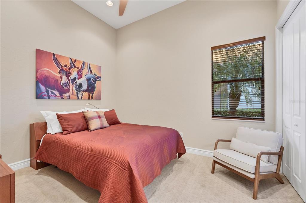 14519 Leopard Creek Place Lakewood Ranch, FL 34202 - Photo 30 of 56 a bedroom with a bed and a couch