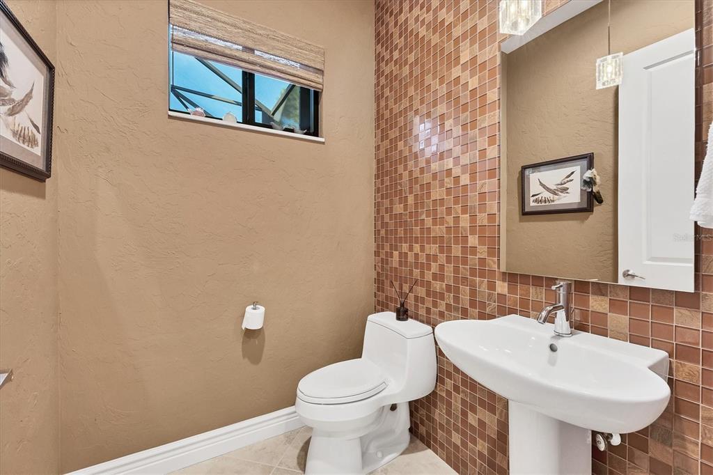 14519 Leopard Creek Place Lakewood Ranch, FL 34202 - Photo 31 of 56 a bathroom with a toilet sink and mirror