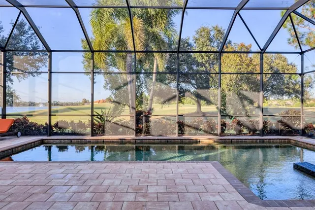 a dining room with furniture a chandelier and window