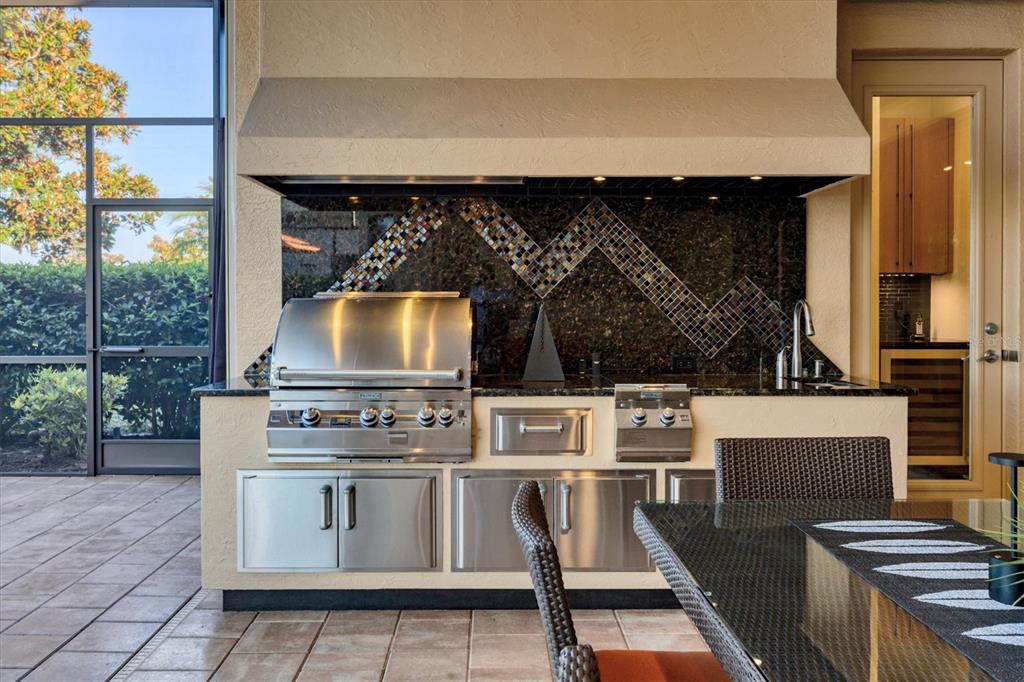 14519 Leopard Creek Place Lakewood Ranch, FL 34202 - Photo 38 of 56 a kitchen with a stove and a microwave