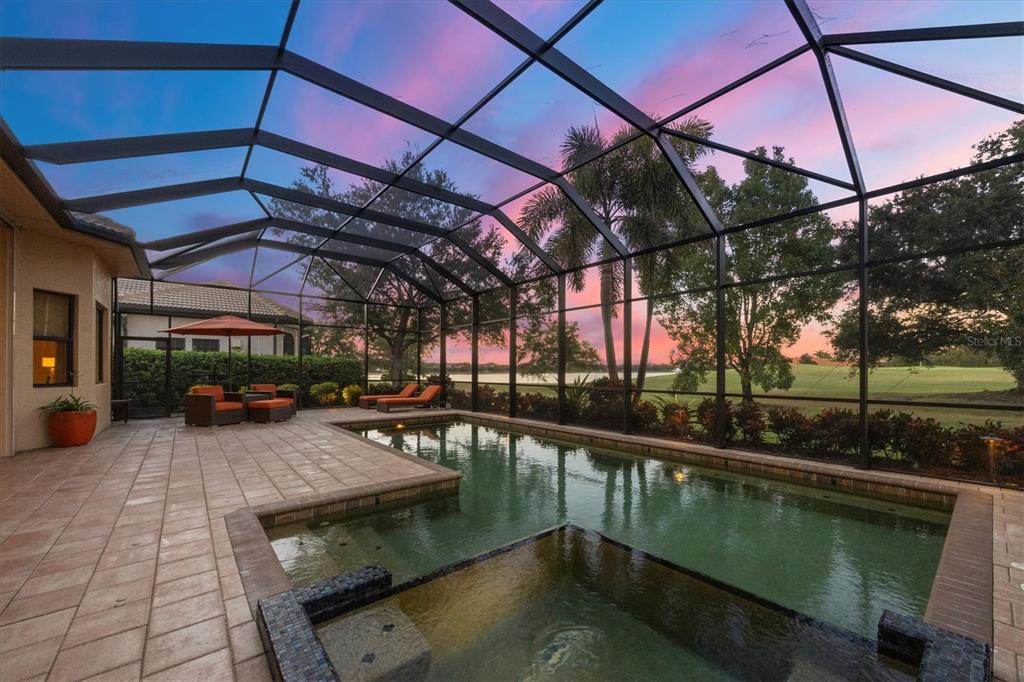 14519 Leopard Creek Place Lakewood Ranch, FL 34202 - Photo 5 of 56 a view of a swimming pool with a patio