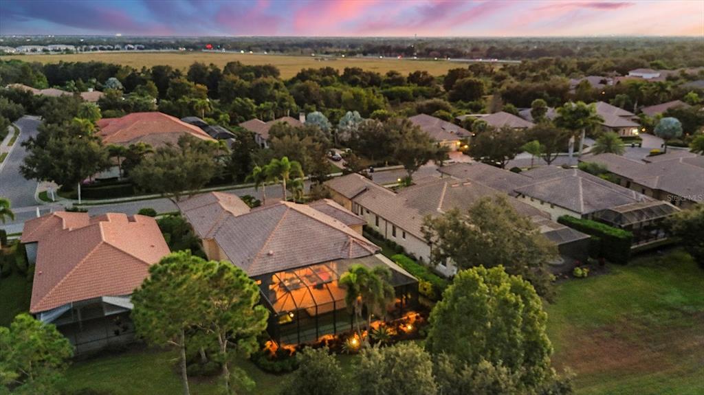 14519 Leopard Creek Place Lakewood Ranch, FL 34202 - Photo 8 of 56 an aerial view of a house with a garden