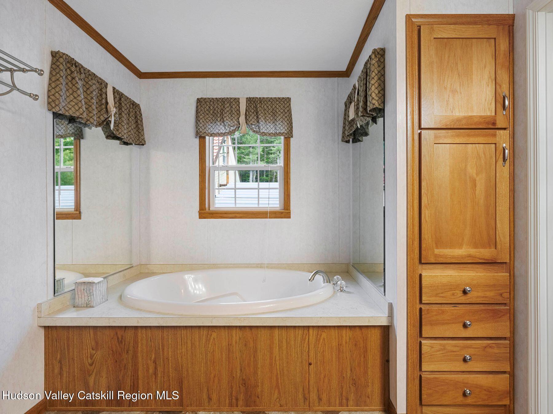 137 Mountain Pond View Road Gilboa, NY 12076 - Photo 29 of 38 a bathroom with a granite countertop sink a mirror and shower