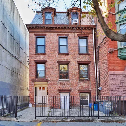 a red brick building that has lot of windows on it