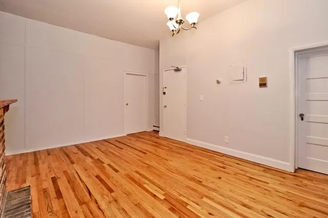 a view of room with wooden floor