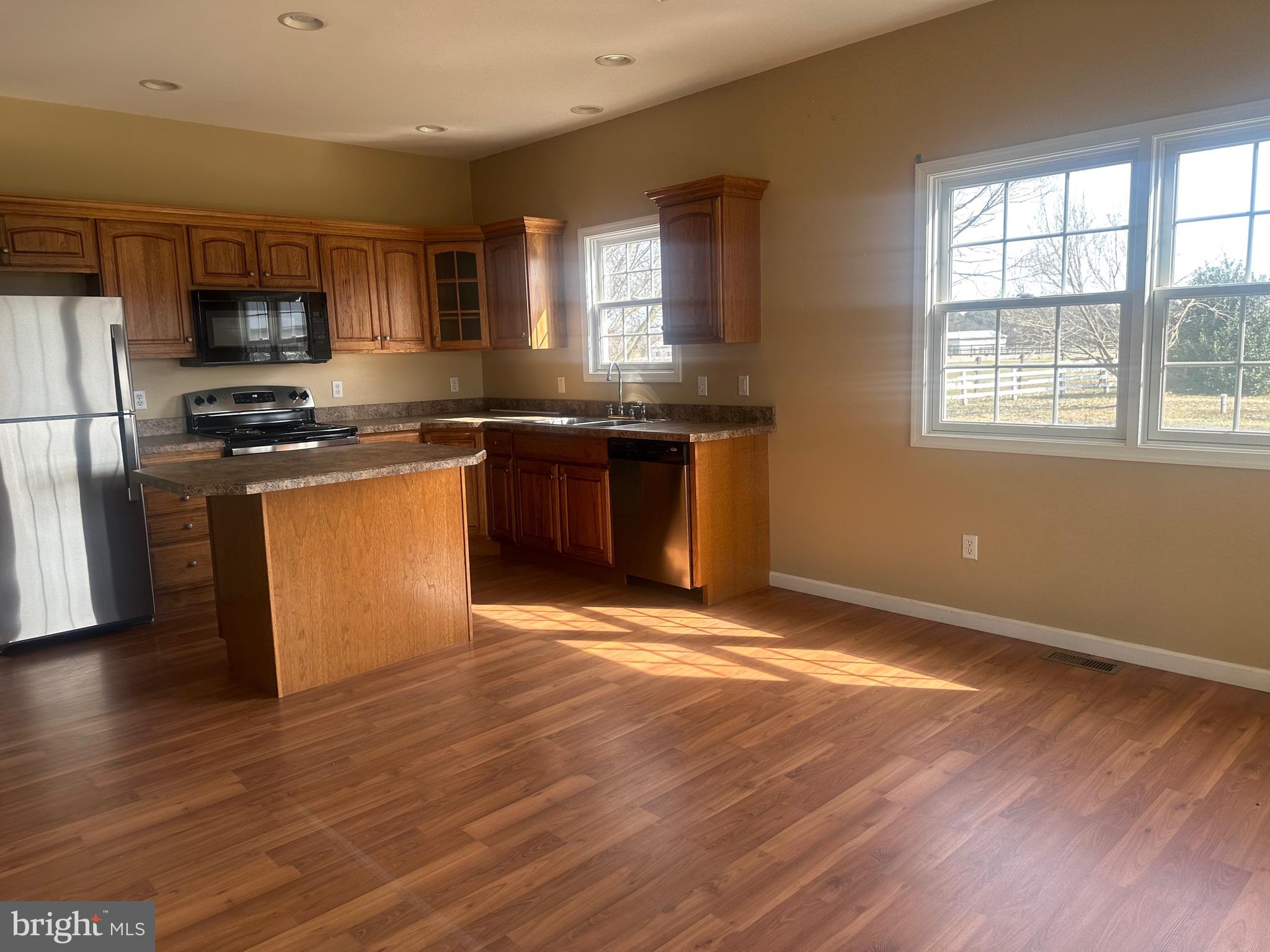 1351 Bohemia Mill Road Middletown, DE 19709 - Photo 11 of 13 a kitchen with stainless steel appliances granite countertop a stove a sink and a microwave
