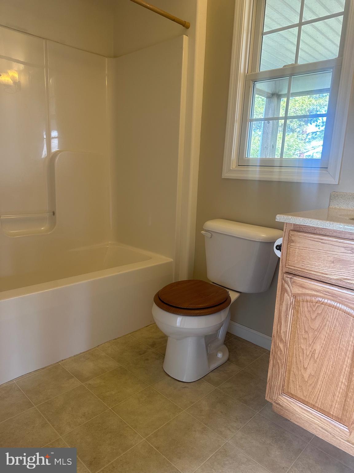 1351 Bohemia Mill Road Middletown, DE 19709 - Photo 13 of 13 a white toilet sitting next to a bath tub