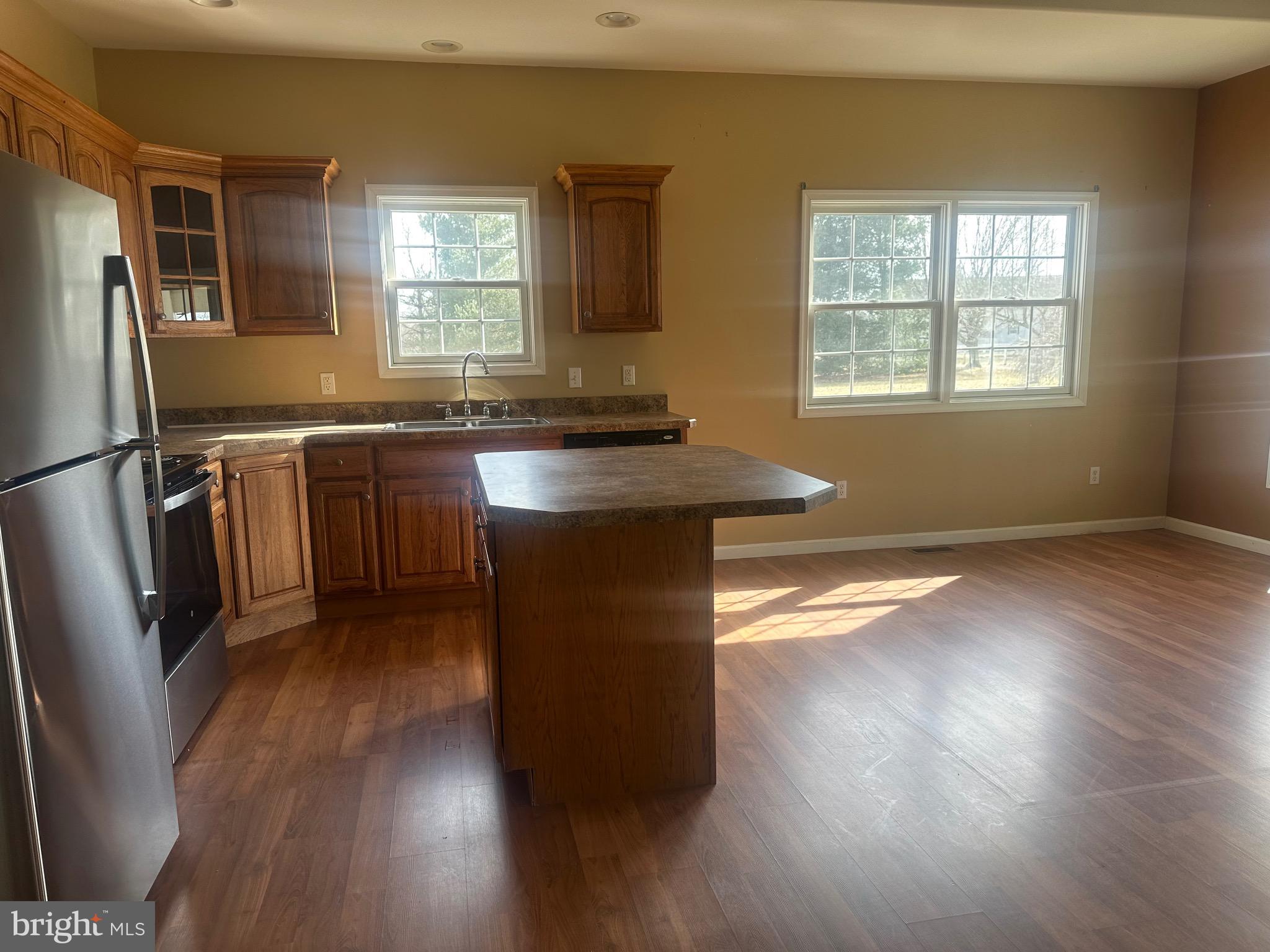 1351 Bohemia Mill Road Middletown, DE 19709 - Photo 3 of 13 a kitchen with stainless steel appliances granite countertop wooden floors and sink