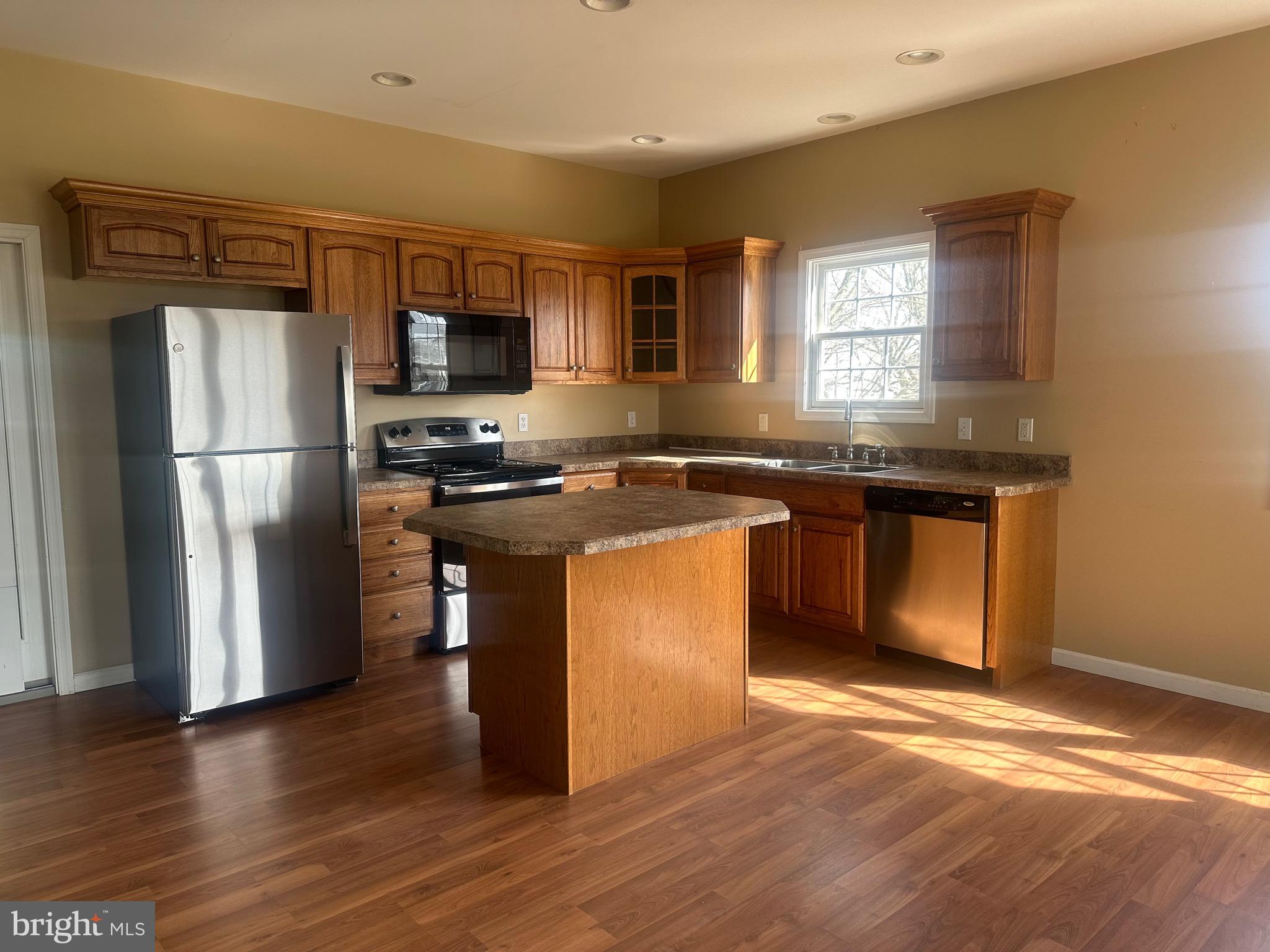 1351 Bohemia Mill Road Middletown, DE 19709 - Photo 4 of 13 a kitchen with stainless steel appliances granite countertop a refrigerator a sink a stove a microwave a counter space and cabinets
