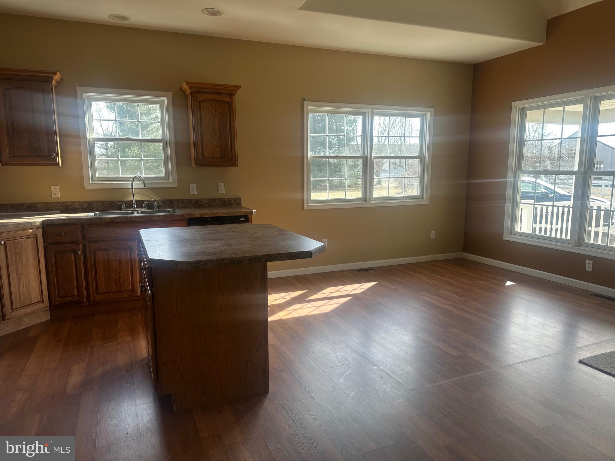 1351 Bohemia Mill Road Middletown, DE 19709 - Photo 7 of 13 a kitchen with wooden floors and wooden cabinets