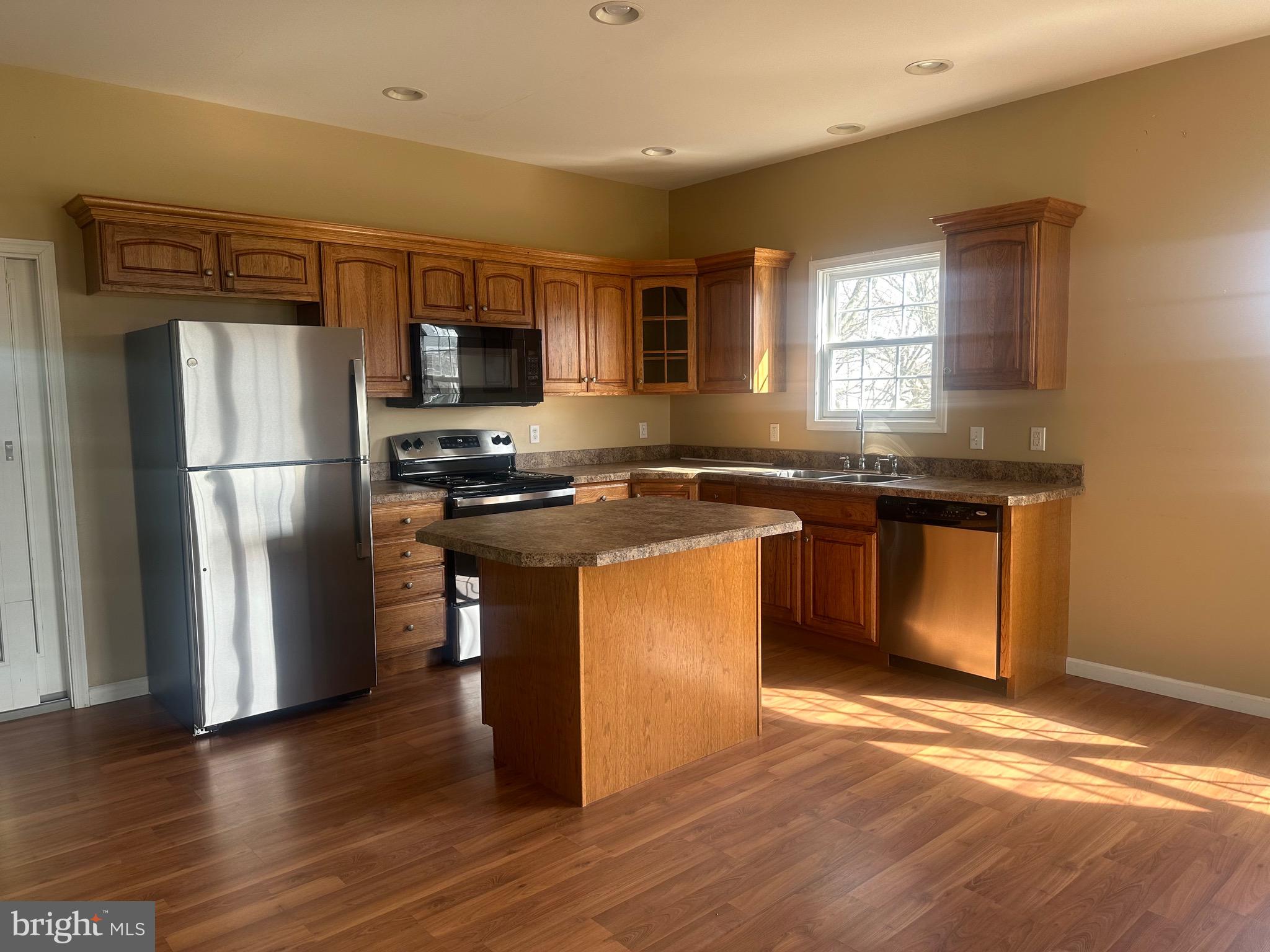 1351 Bohemia Mill Road Middletown, DE 19709 - Photo 9 of 13 a kitchen with a refrigerator sink and wooden floor