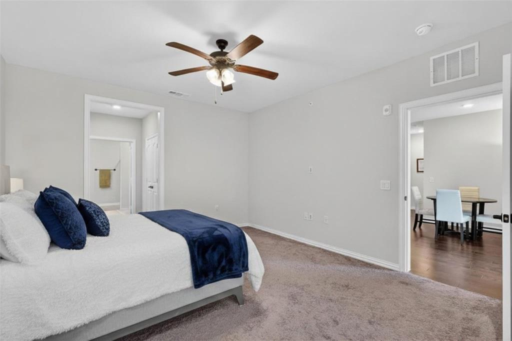 651 Watters Road, Unit 5305 Allen, TX 75013 - Photo 14 of 40 a bedroom with a bed and a chandelier
