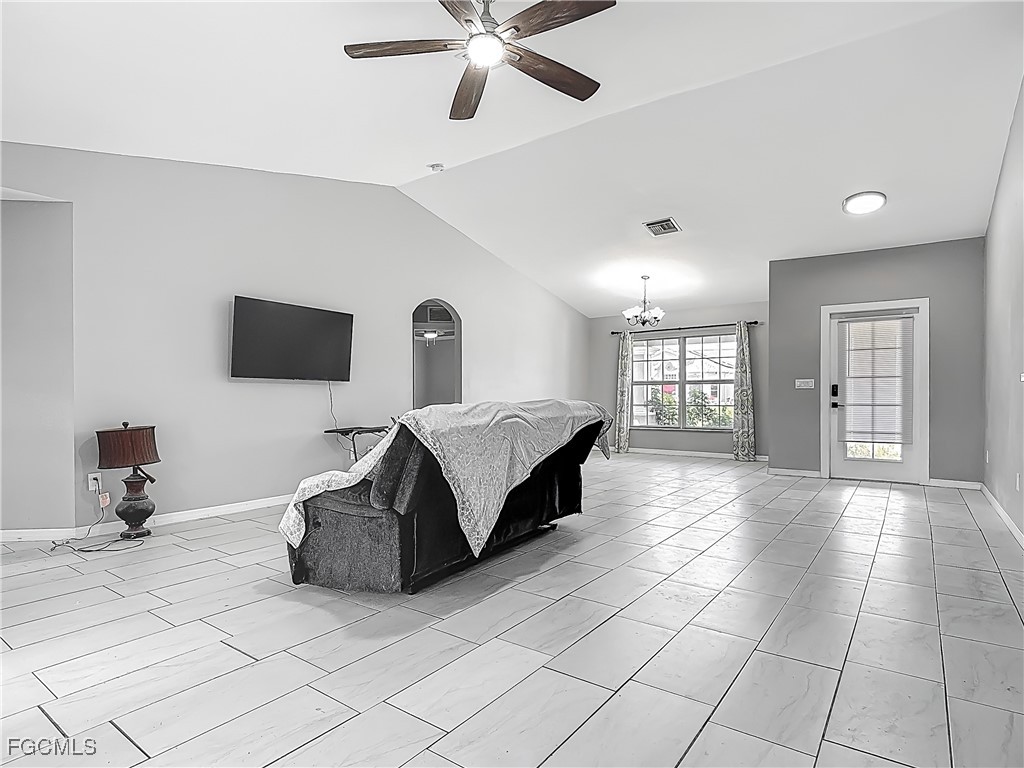 2732 Northwest 3rd Terrace Cape Coral, FL 33993 - Photo 4 of 9 a spacious bedroom with a bed and a chandelier