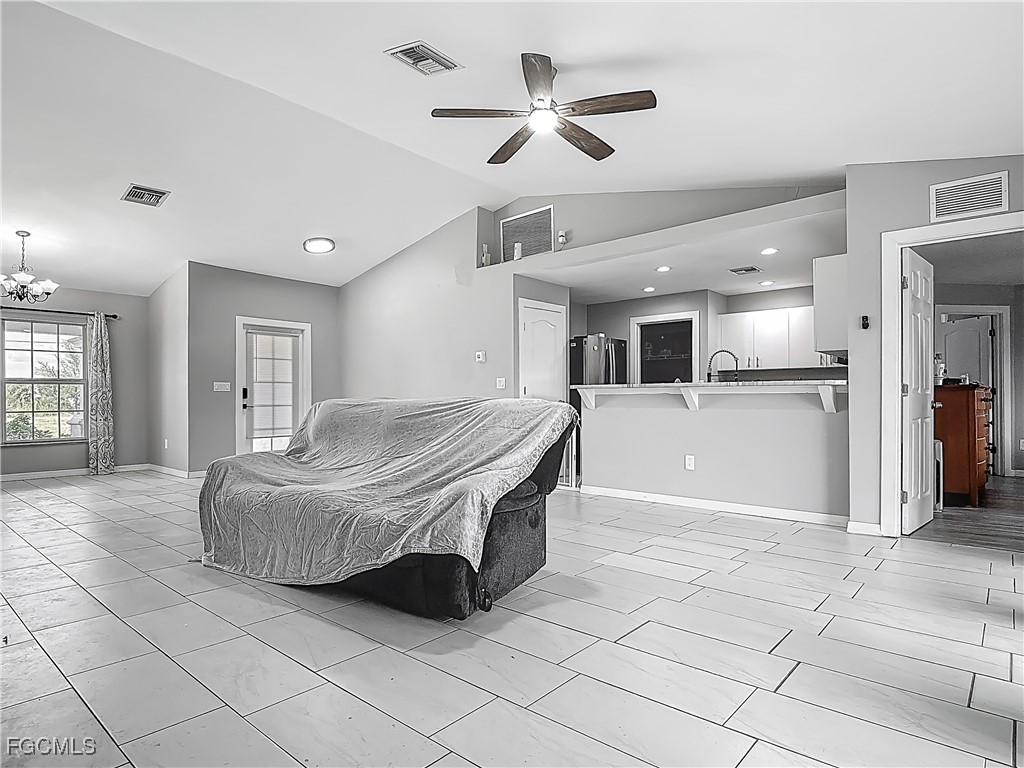 2732 Northwest 3rd Terrace Cape Coral, FL 33993 - Photo 6 of 9 a spacious bedroom with a bed and ceiling fan