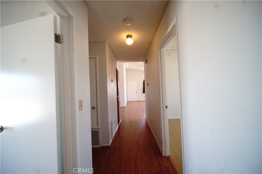 4818 Round Up Road Twentynine Palms, CA 92277 - Photo 14 of 25 a view of a hallway with wooden floor