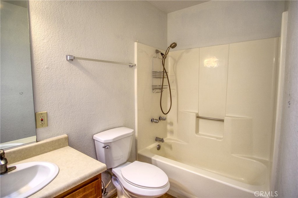 4818 Round Up Road Twentynine Palms, CA 92277 - Photo 15 of 25 a white toilet sitting next to a bath tub