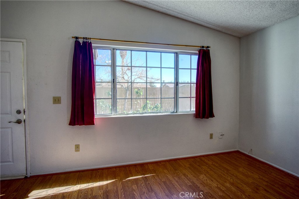 4818 Round Up Road Twentynine Palms, CA 92277 - Photo 2 of 25 a view of a room with wooden floor and windows