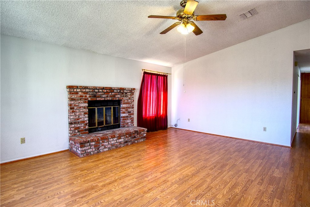 4818 Round Up Road Twentynine Palms, CA 92277 - Photo 4 of 25 an empty room with windows and fireplace