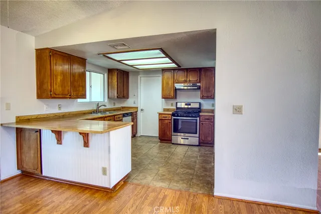 a kitchen with stainless steel appliances granite countertop a stove and a microwave