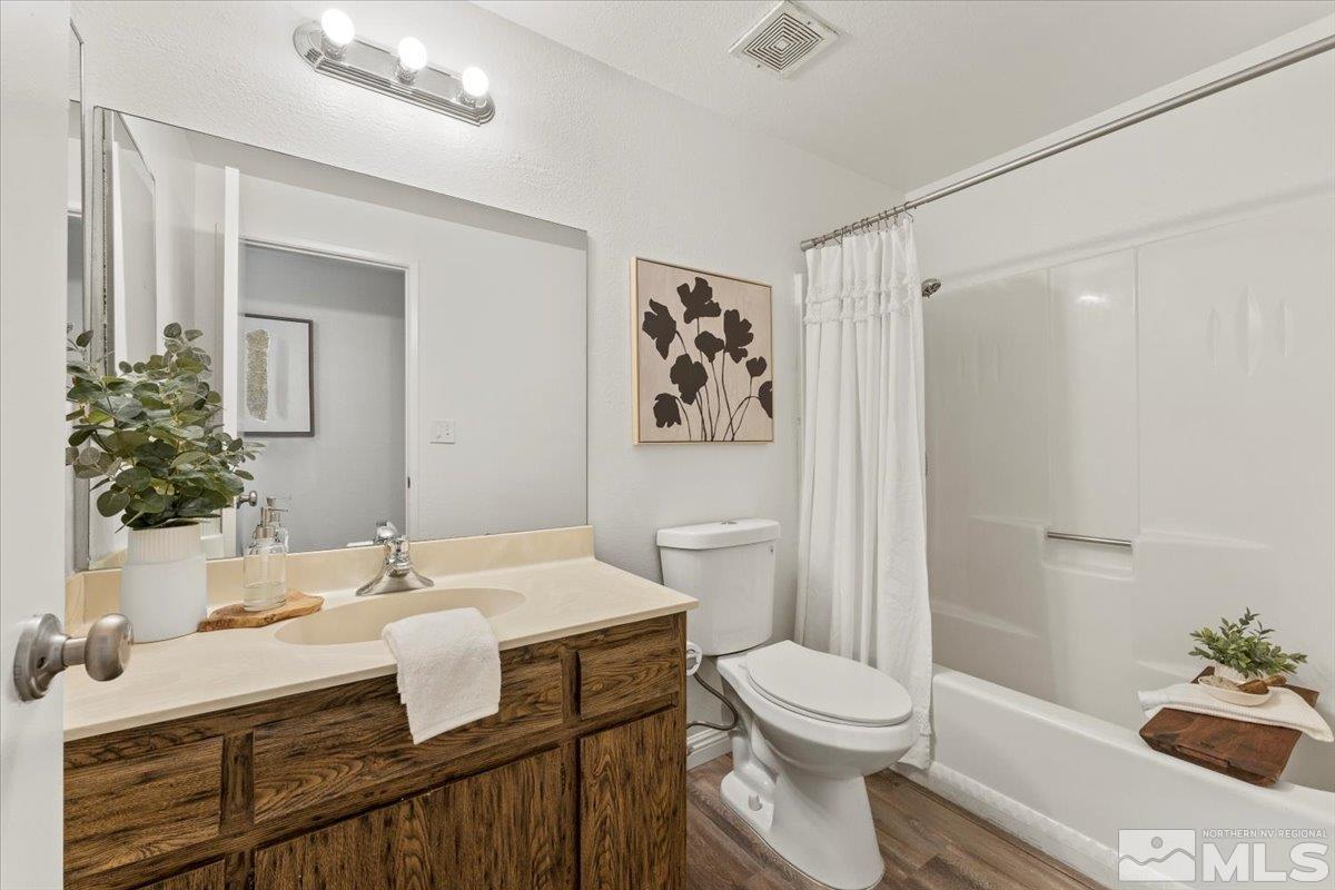 1121 Wagon Wheel Circle Reno, NV 89503 - Photo 21 of 31 a bathroom with a sink a toilet and shower