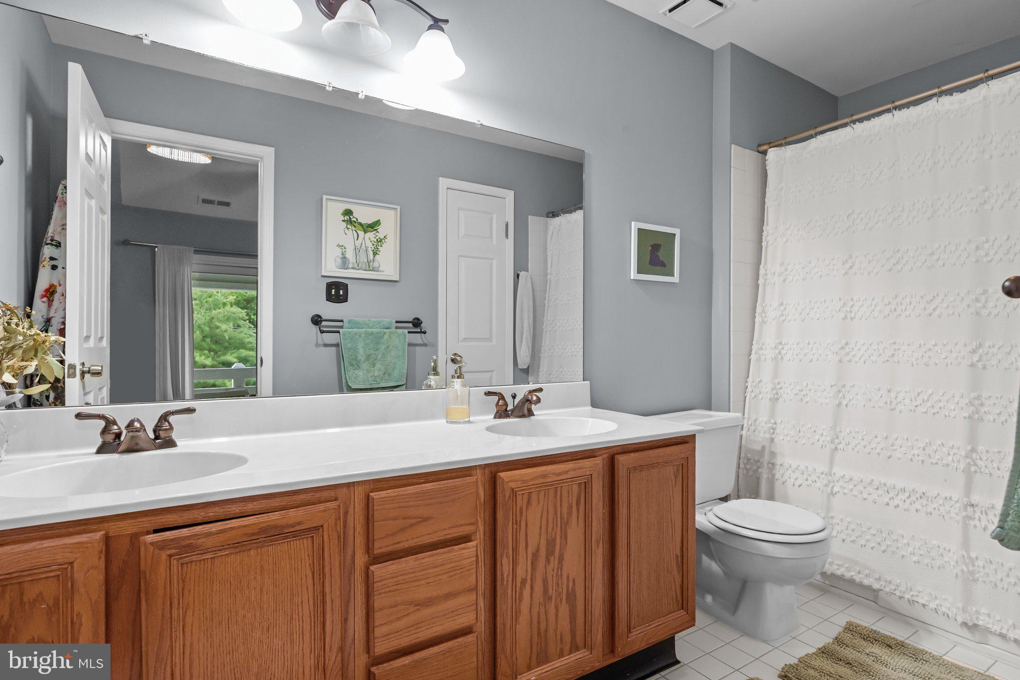 12306 Cornerstone Drive Yardley, PA 19067 - Photo 17 of 25 a bathroom with a granite countertop sink toilet a large mirror and shower