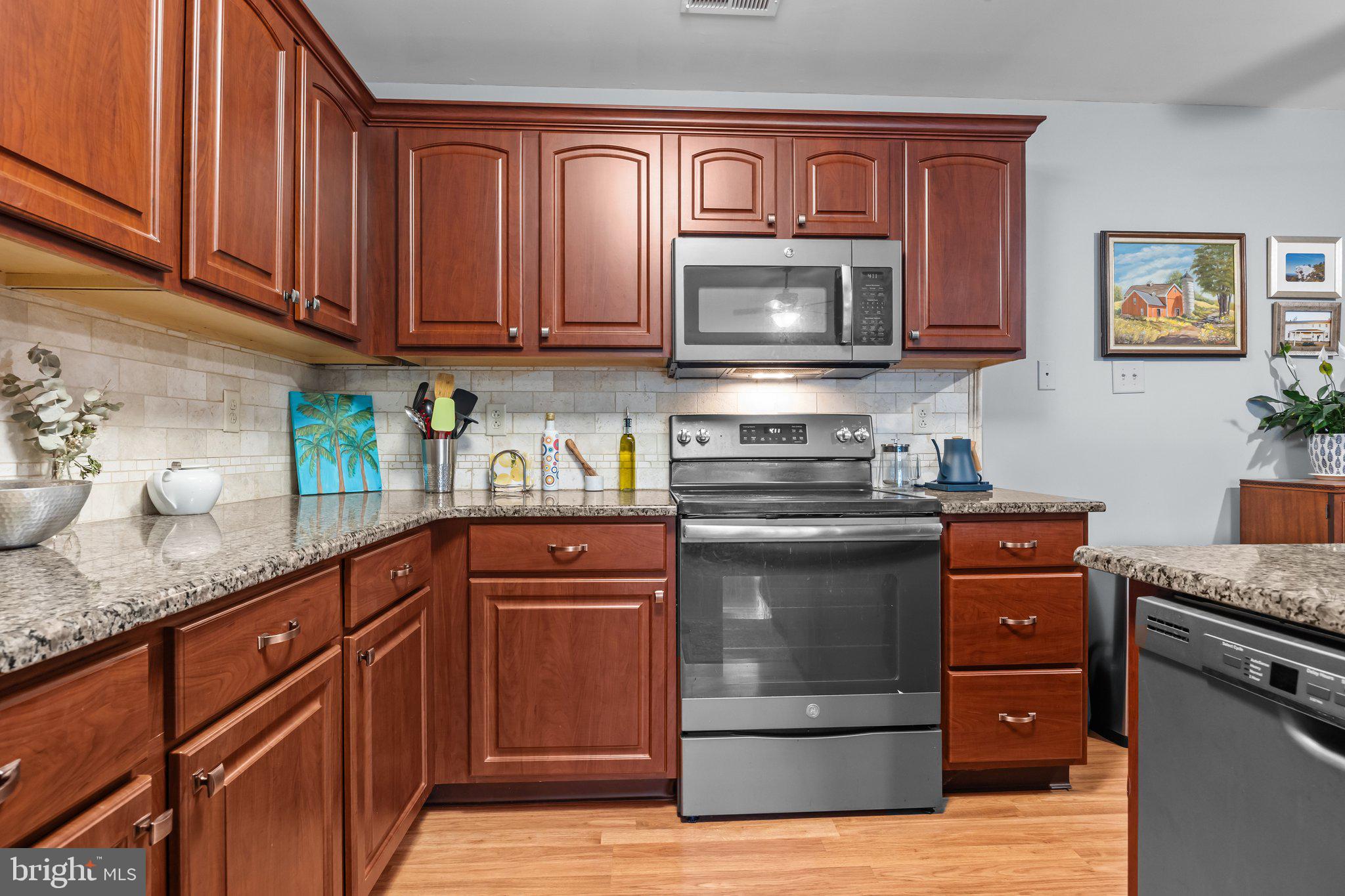 12306 Cornerstone Drive Yardley, PA 19067 - Photo 6 of 25 a kitchen with granite countertop stainless steel appliances and wooden cabinets