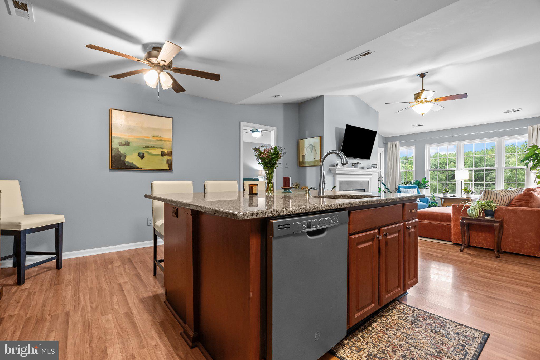 12306 Cornerstone Drive Yardley, PA 19067 - Photo 7 of 25 a kitchen with stainless steel appliances granite countertop a sink dishwasher and a computer on a table with wooden floor