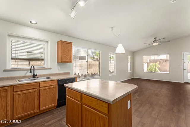 a kitchen with a sink a window and cabinets