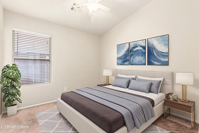 a bedroom with a bed and a painting on the wall