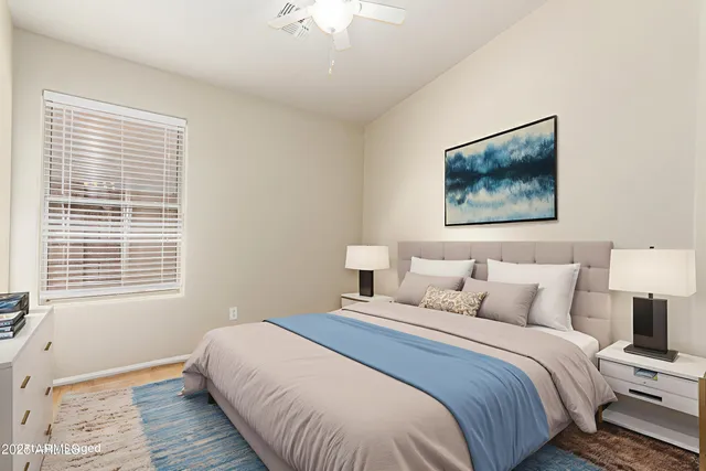 a bedroom with a bed and a window