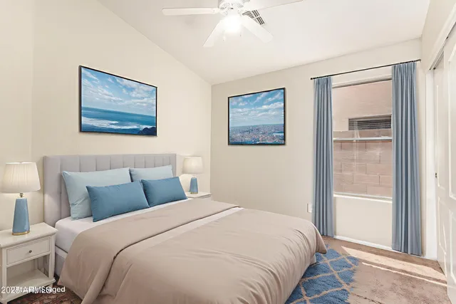 a bedroom with a bed and a painting on the wall