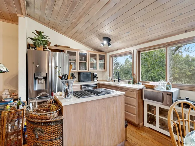 a room with furniture a flat screen tv and next to a window