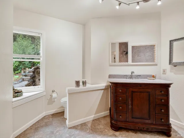 a bathroom with a tub sink and mirror