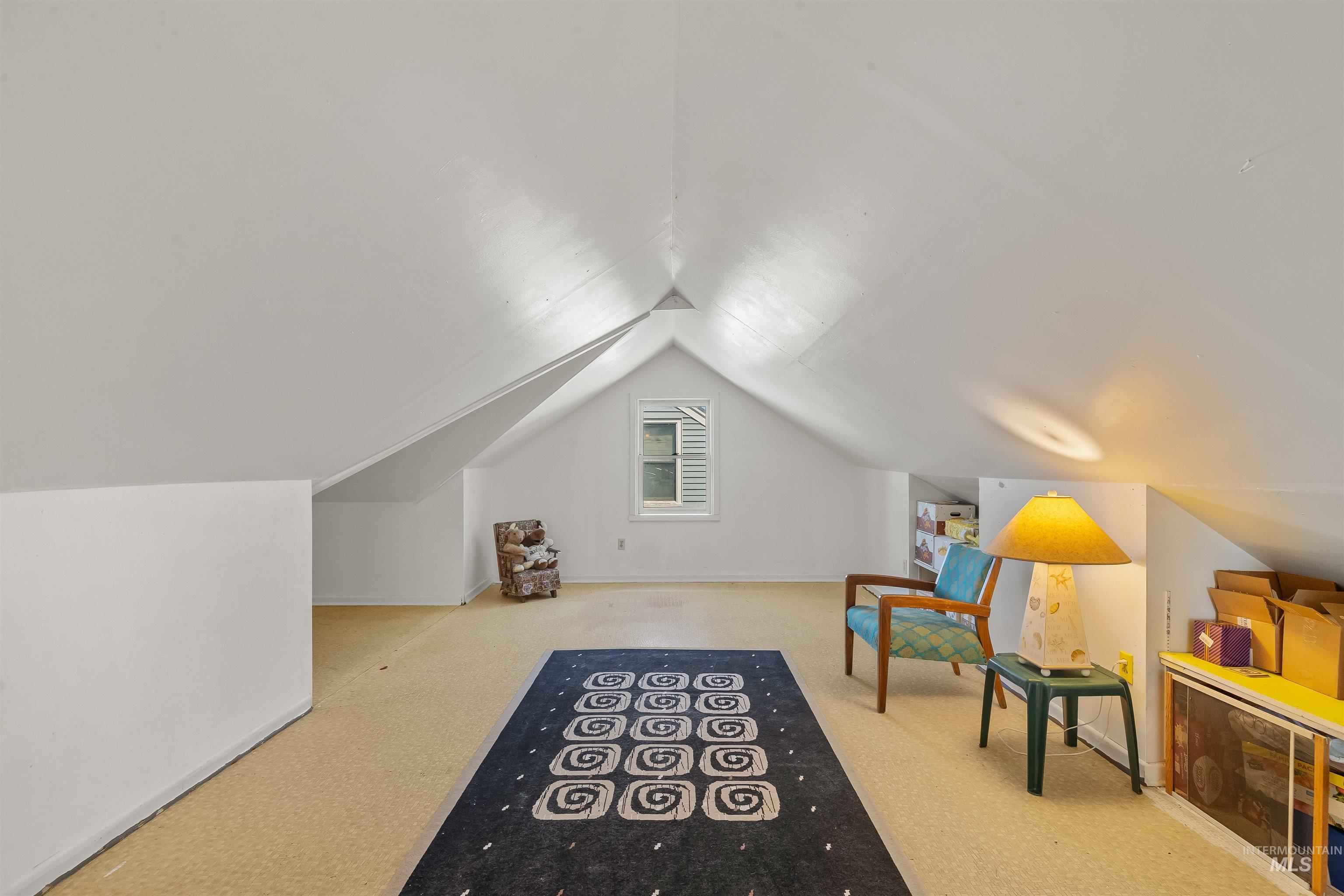 924 N Street Lewiston, ID 83501 - Photo 27 of 46 Expansive attic space featuring a vaulted ceiling and window with louvered shutters