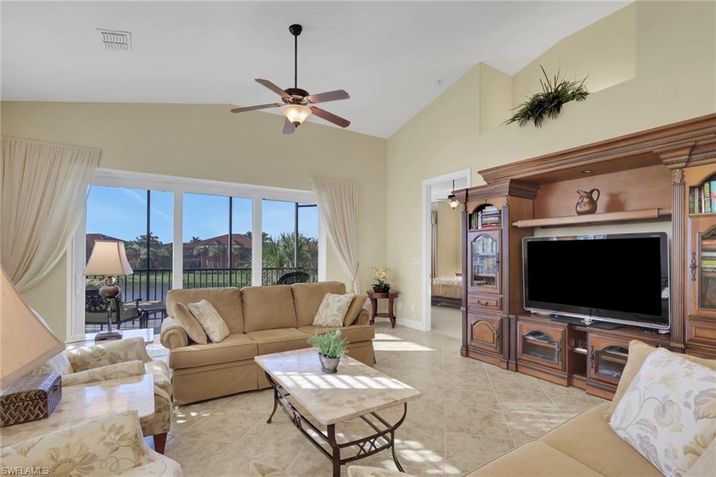 6397 Legacy Circle, Unit 2003 Naples, FL 34113 - Photo 11 of 26 a living room with furniture and a flat screen tv