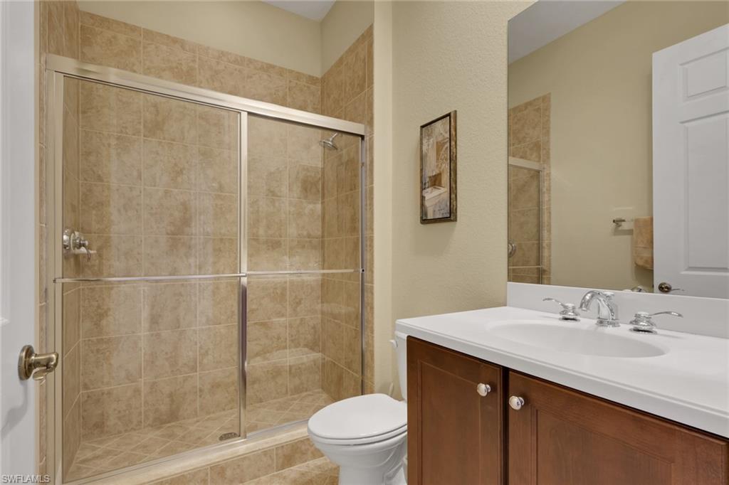 6397 Legacy Circle, Unit 2003 Naples, FL 34113 - Photo 19 of 26 a bathroom with a sink shower and a toilet