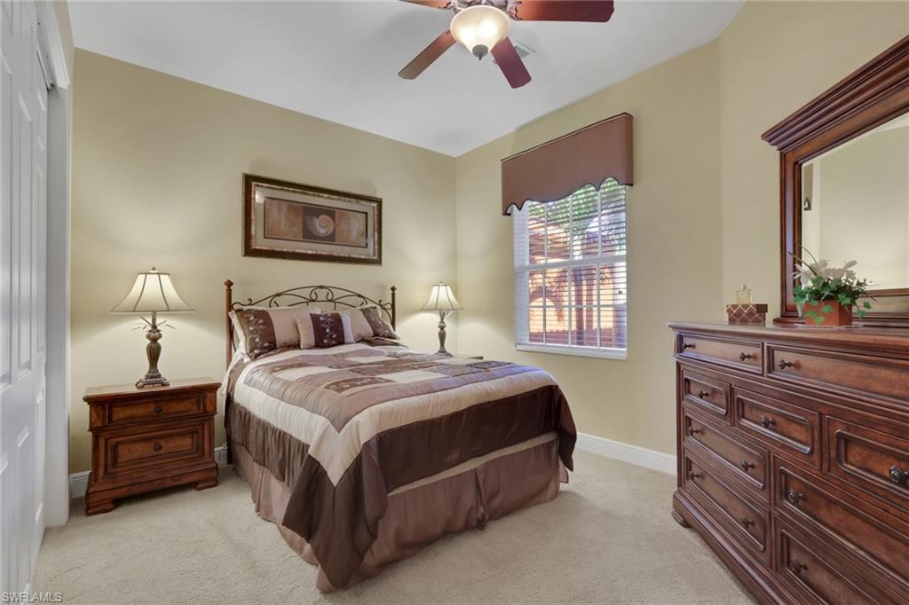 6397 Legacy Circle, Unit 2003 Naples, FL 34113 - Photo 20 of 26 a bedroom with a bed and a dresser