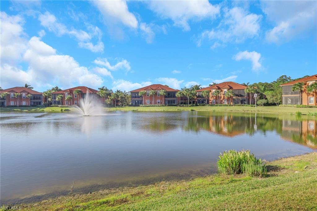 6397 Legacy Circle, Unit 2003 Naples, FL 34113 - Photo 2 of 26 a view of a lake with houses in the back