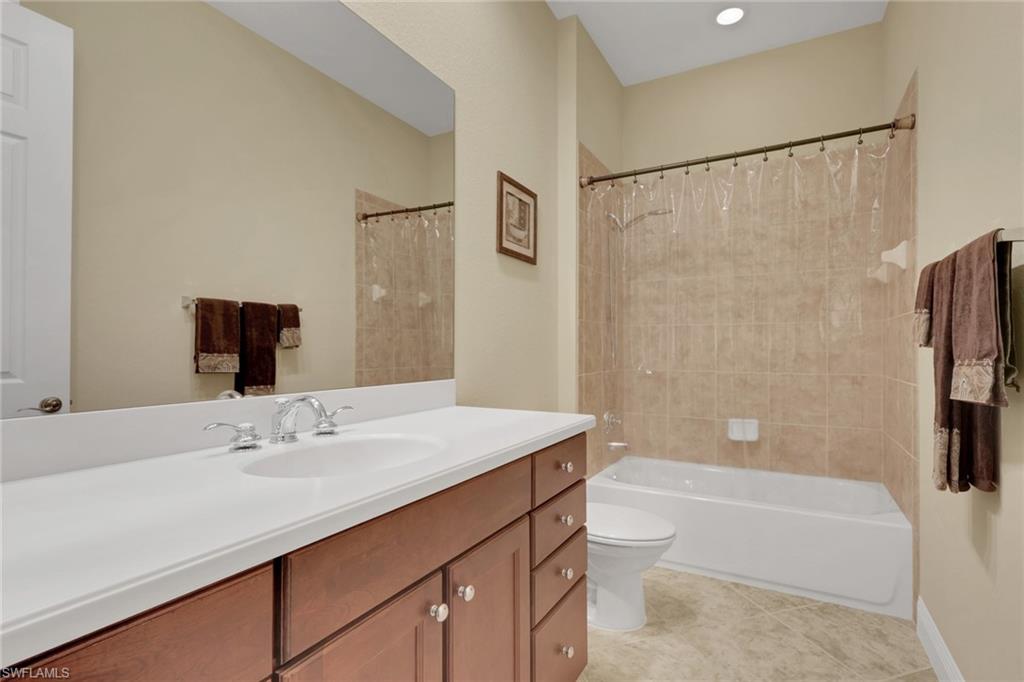 6397 Legacy Circle, Unit 2003 Naples, FL 34113 - Photo 21 of 26 a bathroom with a sink a toilet and shower