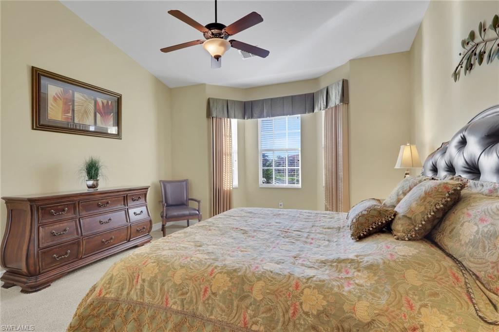 6397 Legacy Circle, Unit 2003 Naples, FL 34113 - Photo 23 of 26 a bedroom with a large bed and a window